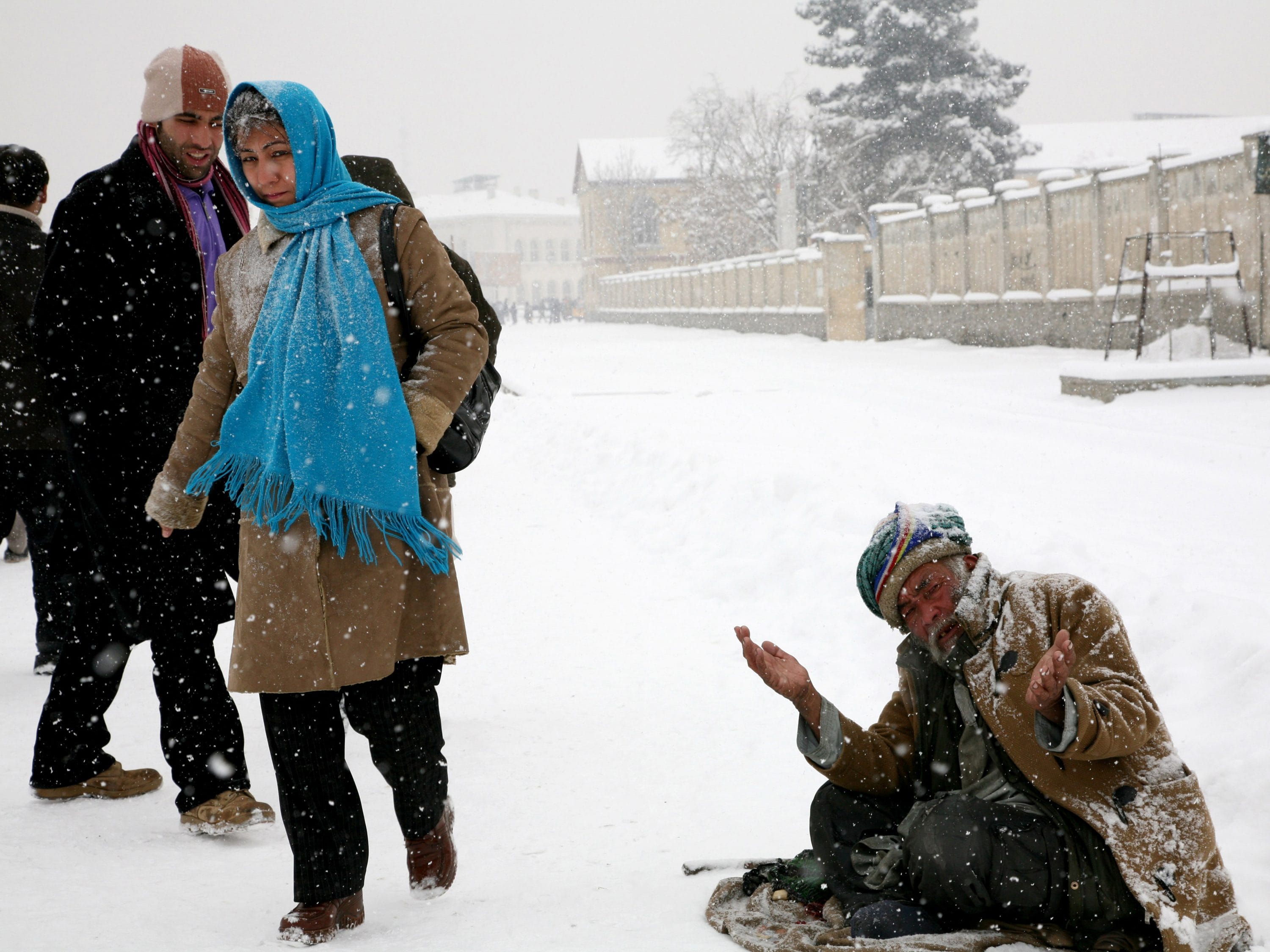Poverty still drives people out of their homes, even on a snowy day, to earn a living.
