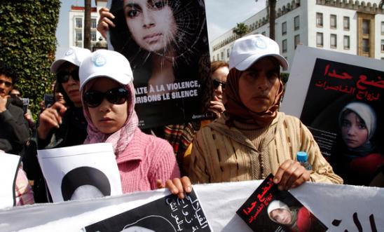 189007_activists_from_various_women_s_rights_associations_gather_while_holding_placards_as_they_protest_against_the_suicide_of_amina_al-filali_16_who_was_forced_to_marry_the_man_who_raped_her_in_rabat
