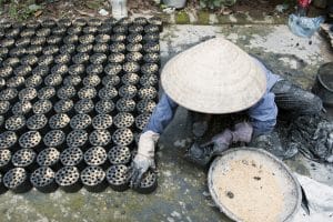 29 June, 2011-Ba Trang, Vietnam: A housewife makes briquette to sell in the village. In developing countries some 2.5 billion people are forced to rely on biomass—fuelwood, charcoal and animal dung—to meet their energy needs for cooking. (UN Millennium Development Goals Report 2007) Photo Credit:Kibae Park/UN Photo