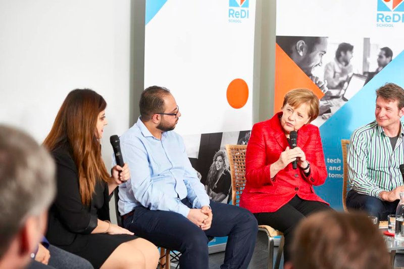 Chancellor Merkel speaking with Luna Benndakji