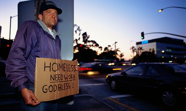 A homeless man stands on a street corner Photograph by Joel Stettenheim CORBIS