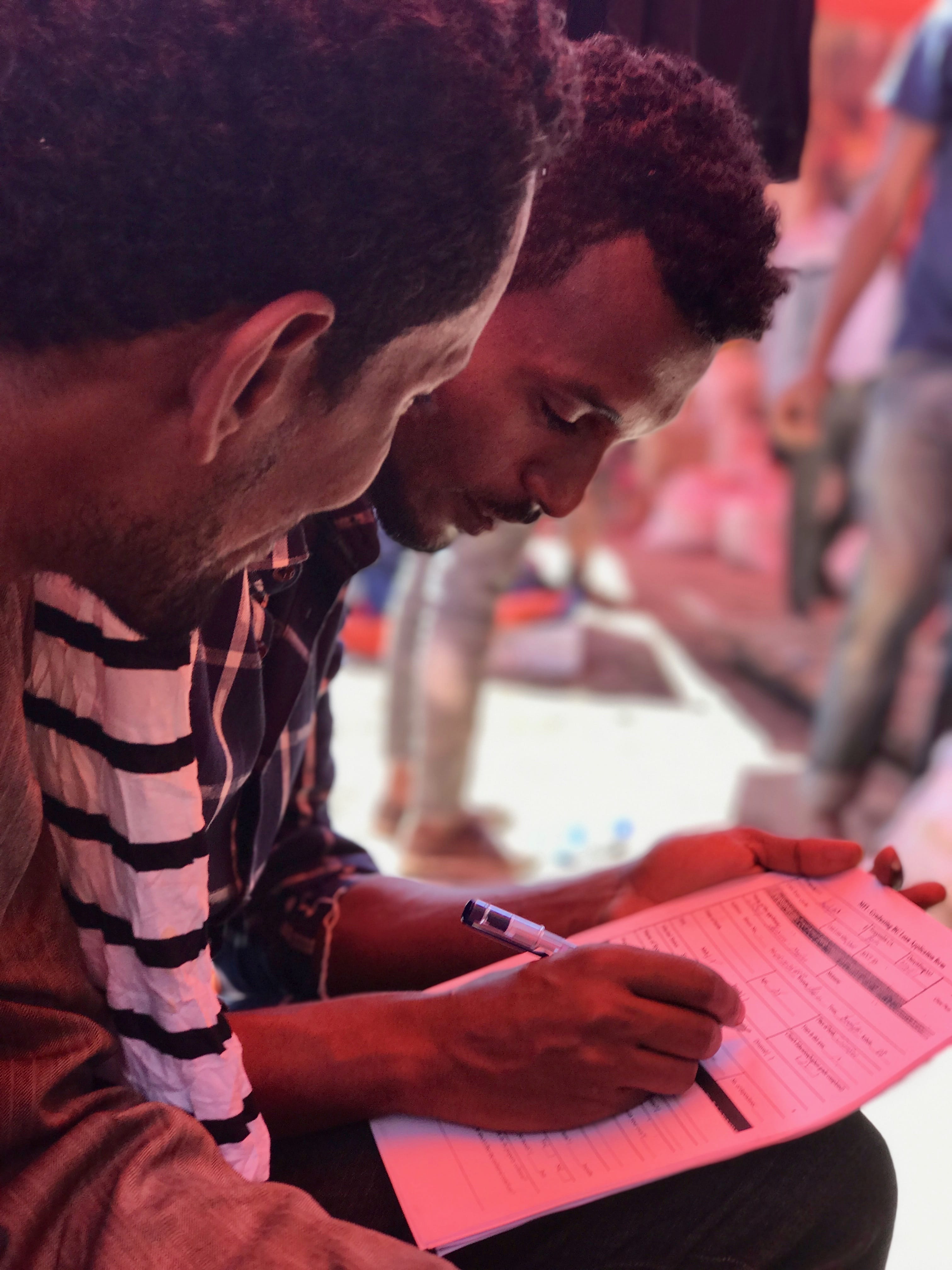 Loan officer completing paper application form