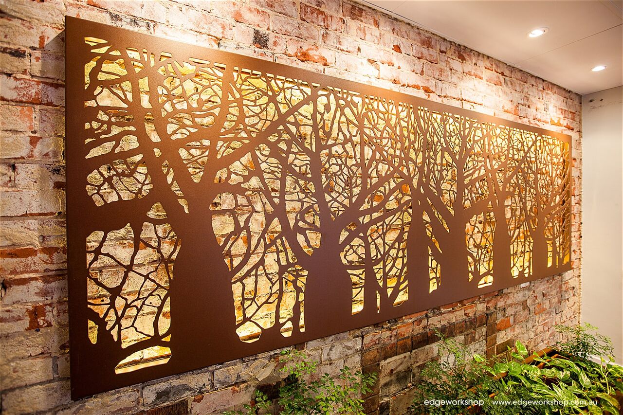 tree cut out breaking up wall lighting