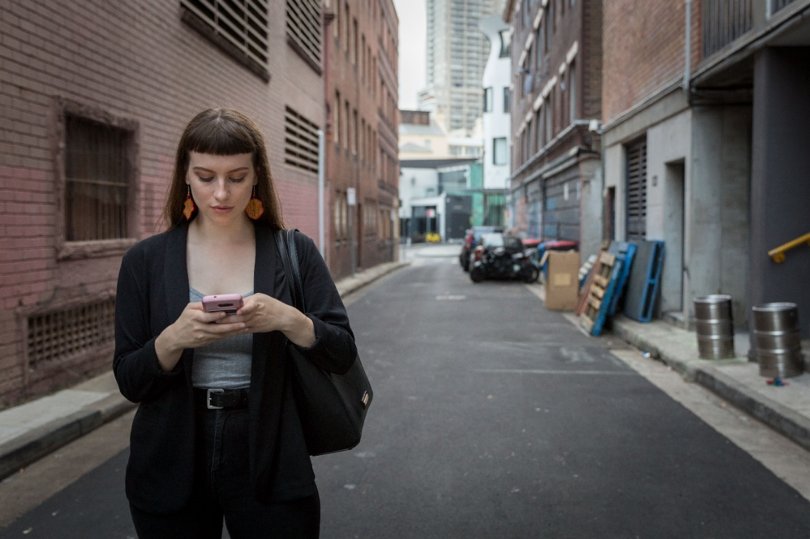 A young woman in Sydney uses the Free to Be app to drop a pin 