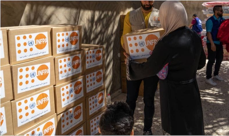 Woman taking UNFPA box
