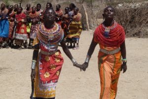 Two Kenyan women holding hands