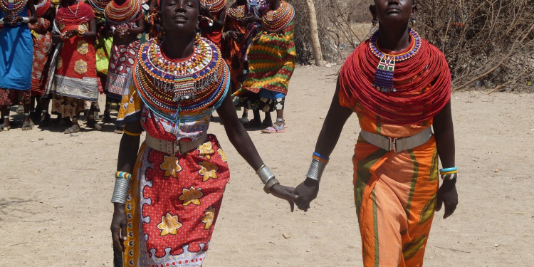 Two Kenyan women holding hands
