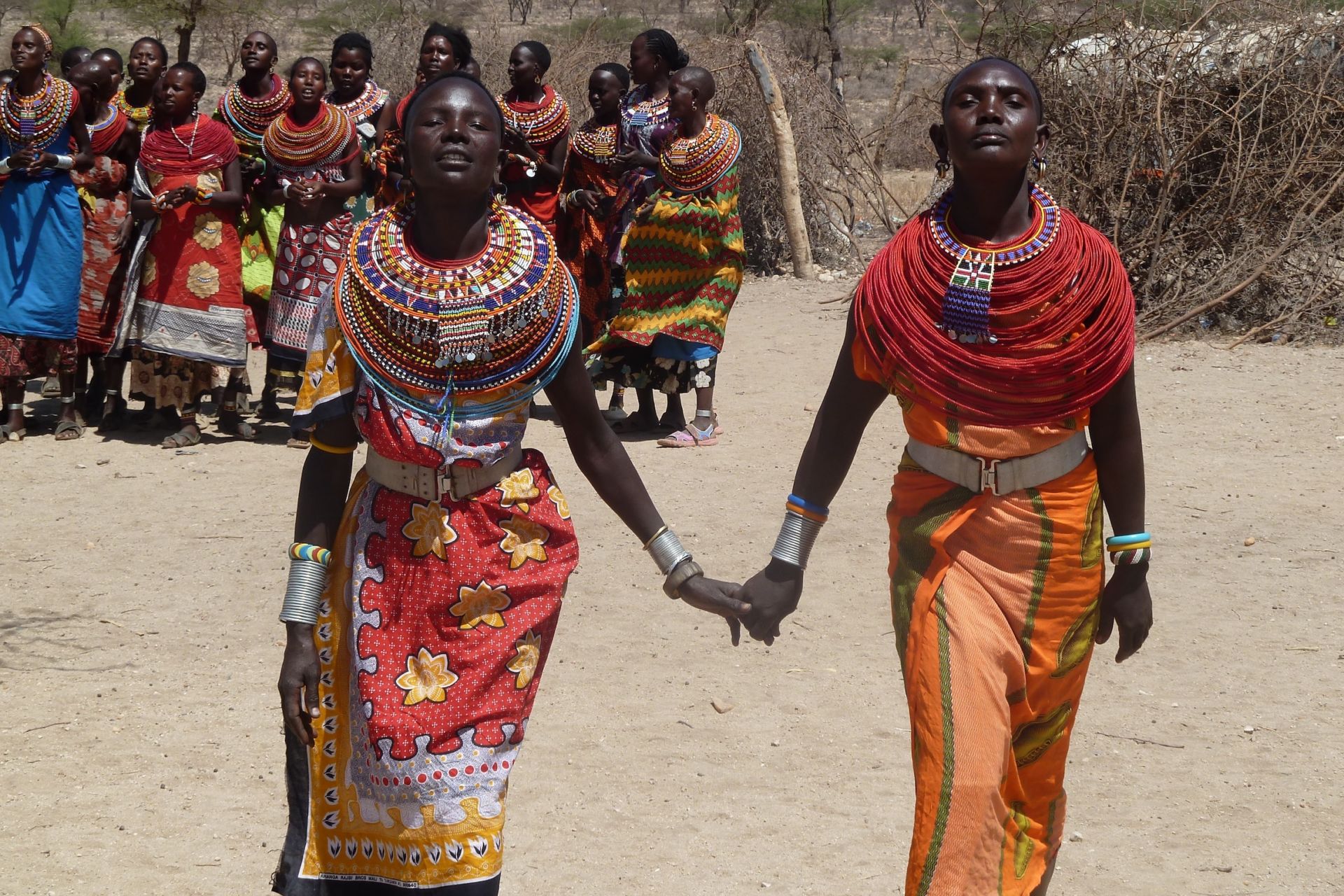 Two Kenyan women holding hands