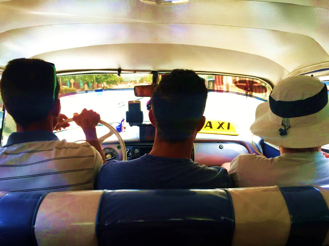 Chad and Liam seated with the taxi driver
