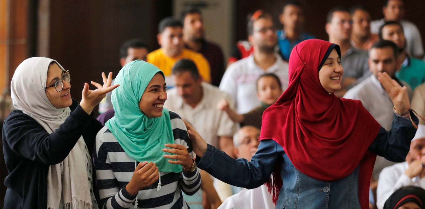 Family members and relatives of Muslim Brotherhood members, on trial for an armed sit-in at Rabaa square, wave and cheer them on at a court on the outskirts of Cairo, Egypt May 31, 2016. Credit: Reuters