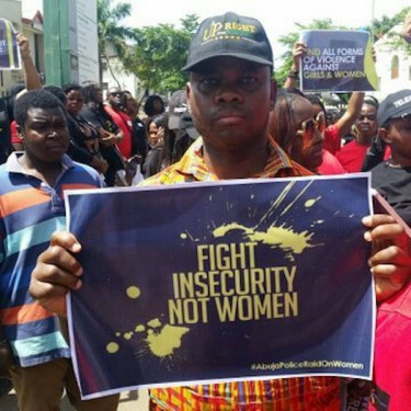 Men protesting the Abuja raid