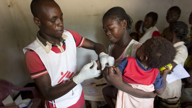 A health worker for Doctors Without Borders checks patients at a mobile clinic in the village of Zere in the Central African Republic.