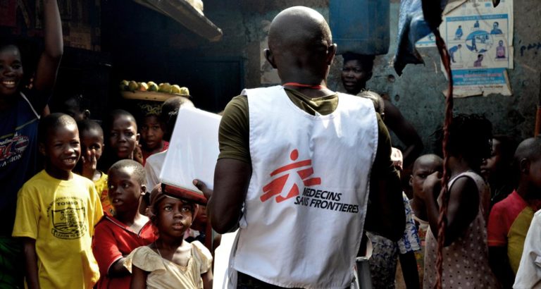 Humanitarian aid worker with people
