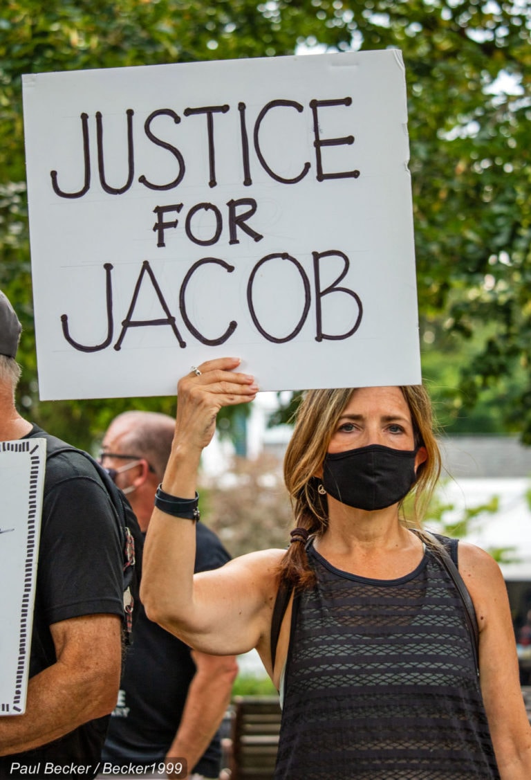 Kenosha protestor holding a banner.