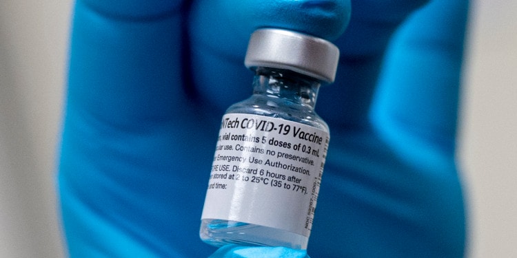 Army Spc. Angel Laureano holds a vial of the COVID-19 vaccine, Walter Reed National Military Medical Center, Bethesda, Md., Dec. 14, 2020. (DoD photo by Lisa Ferdinando)