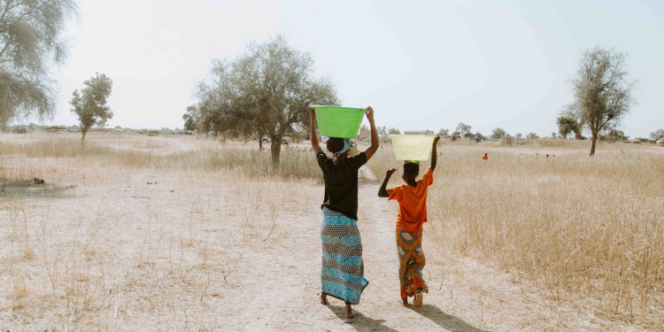 Women carrying water home from the well in Linguere, Senegal.
