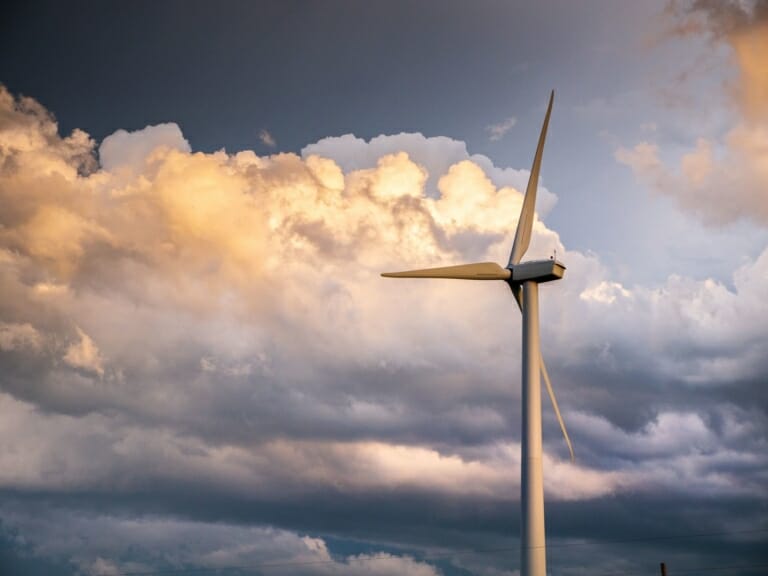 Windmill under a cloudy sky harvesting wind energy