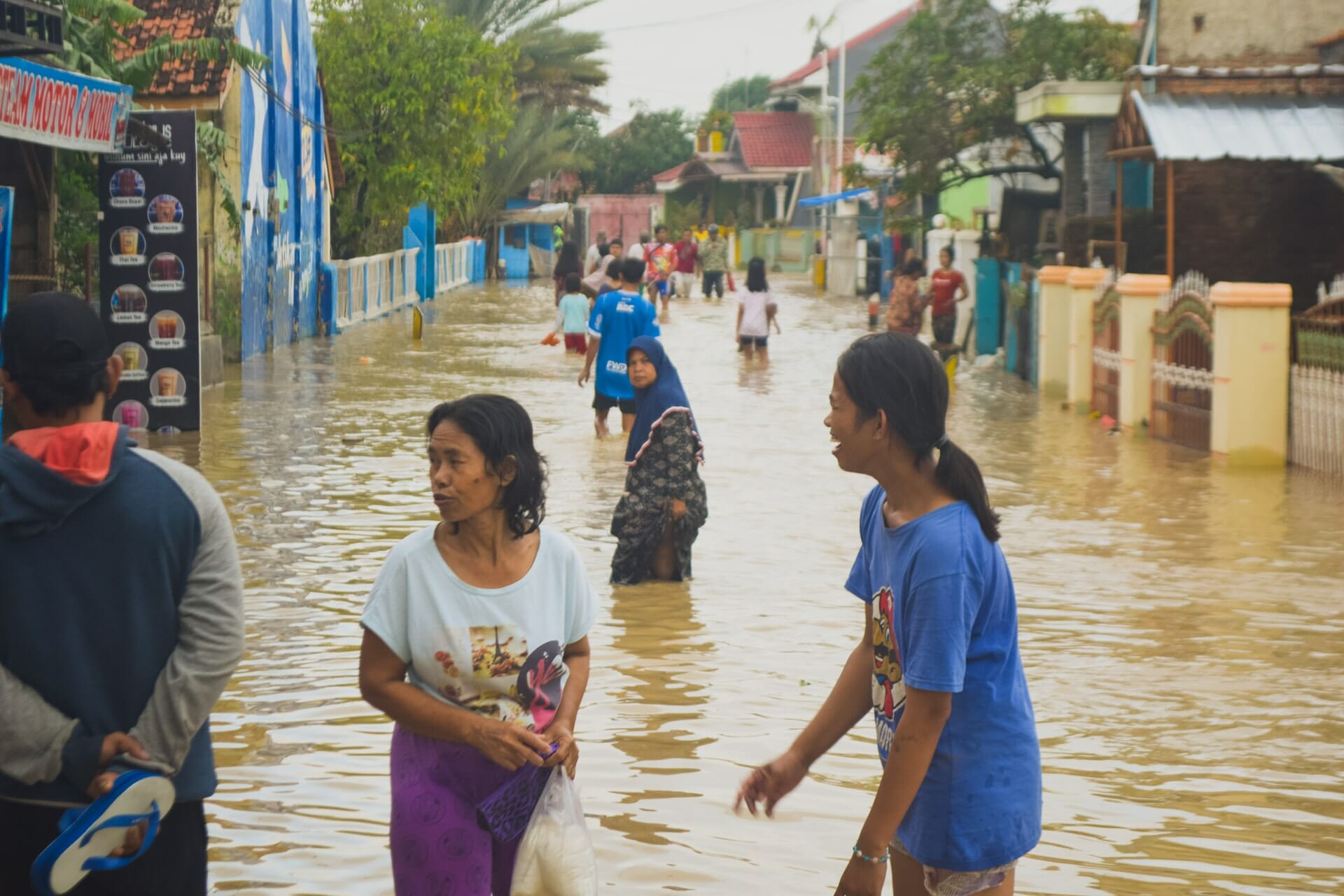 A group of people walking in a flooded street