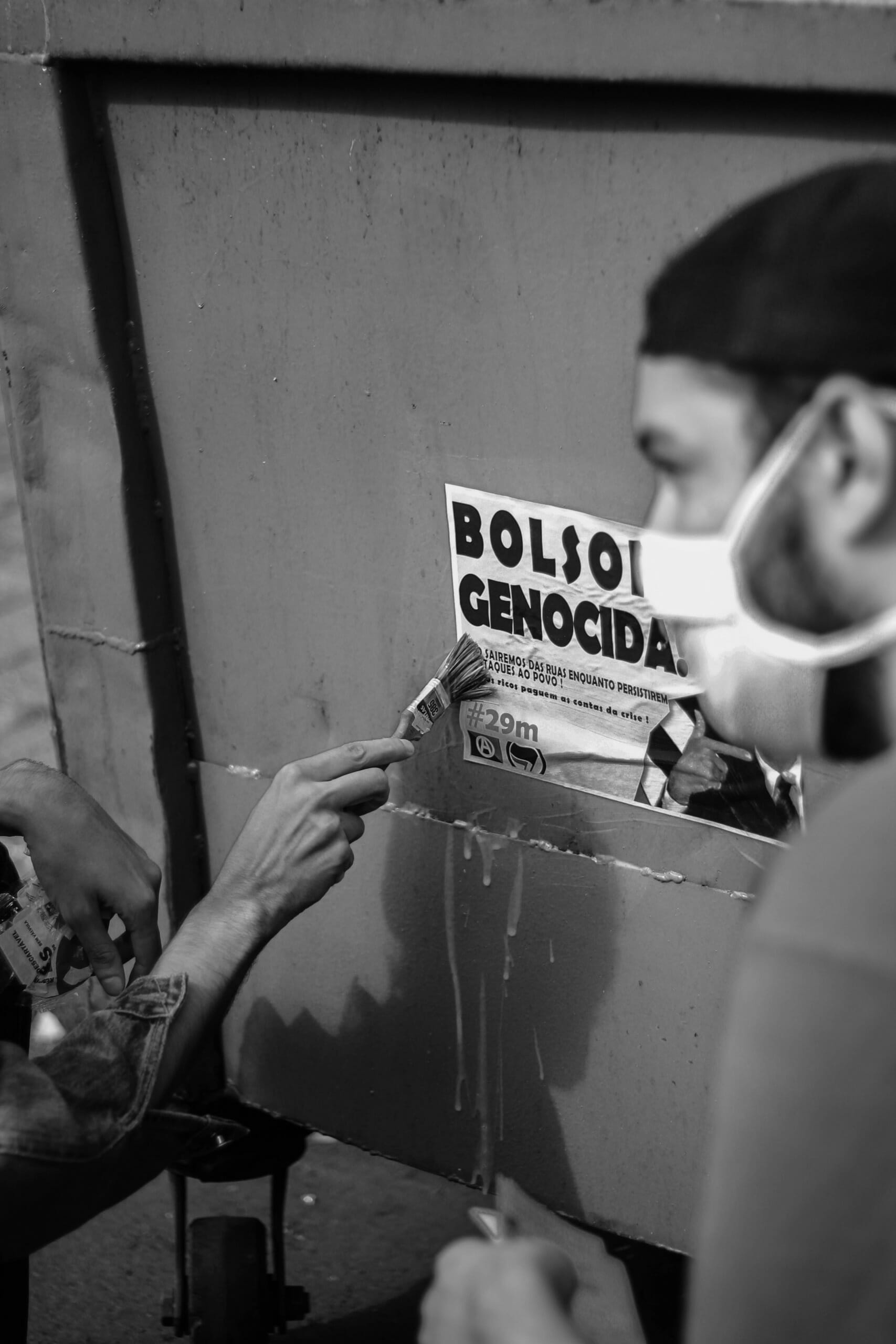 protesters put up poster against bolsonaro