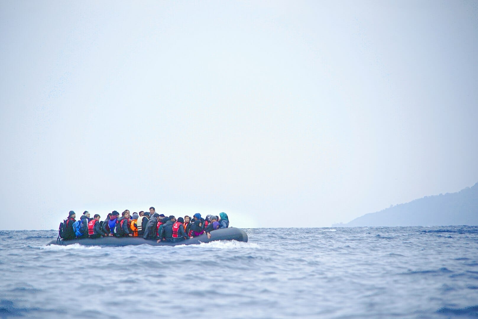 inflatable boat filled with immigrants at sea
