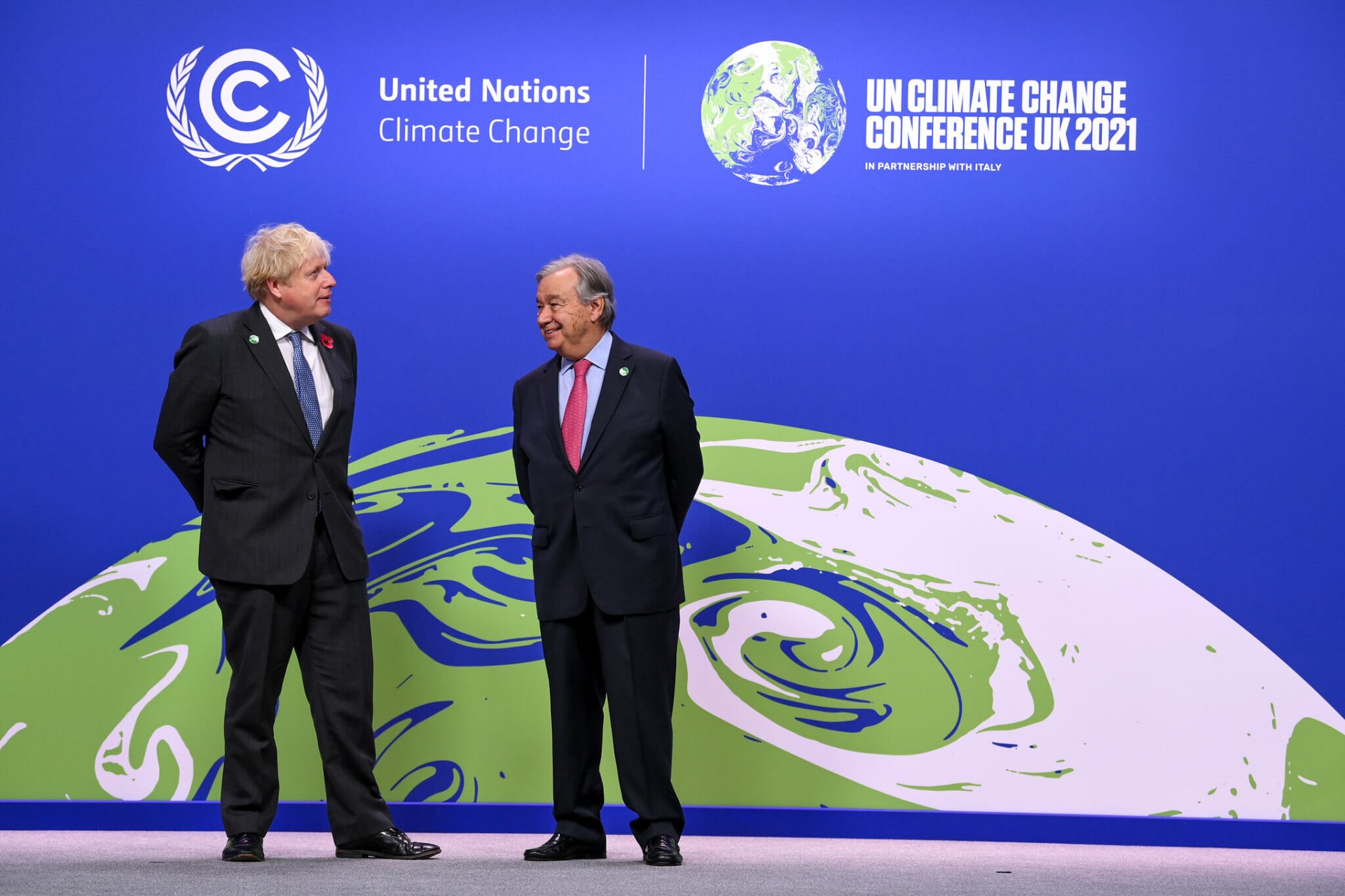 two men talking to each other at COP26