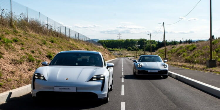 two cars racing on a road
