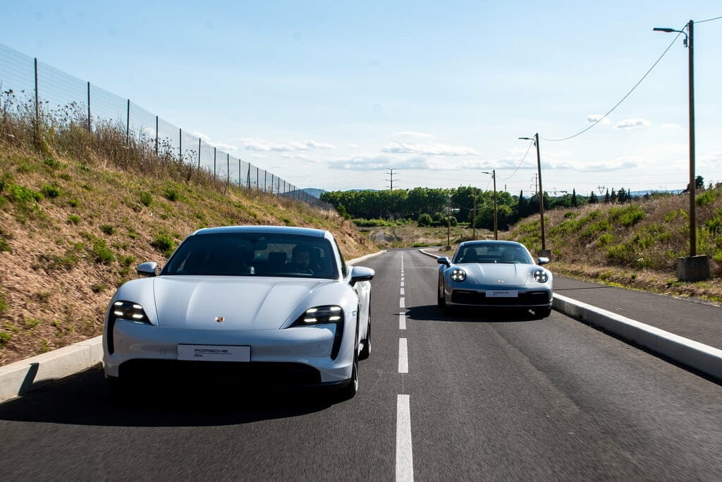 two cars racing on a road