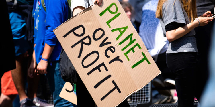 planet over profit protest sign