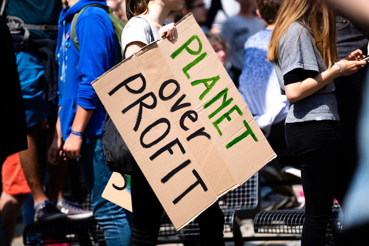 planet over profit protest sign