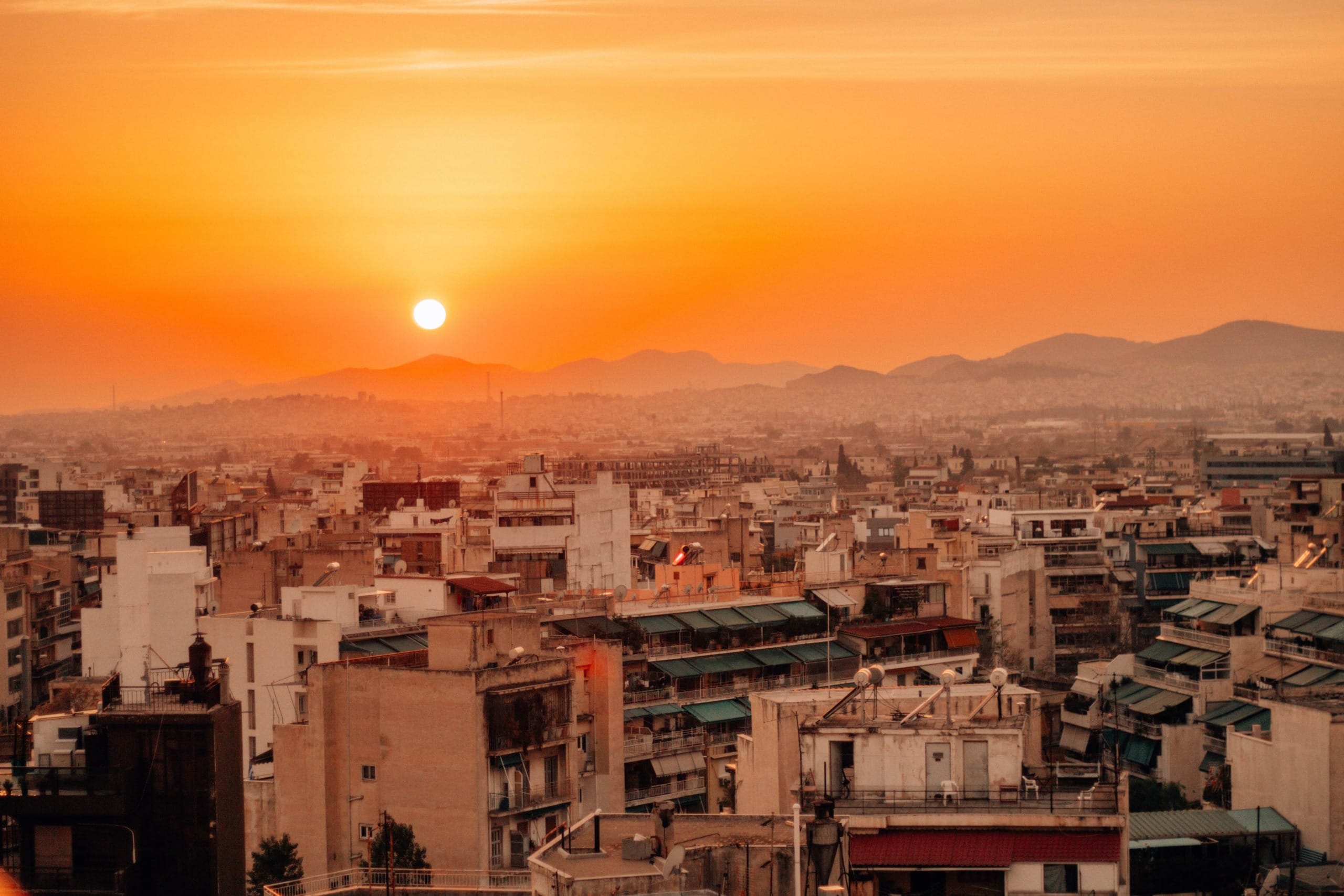 A densely packed urban area in Athens, Greece at sunset