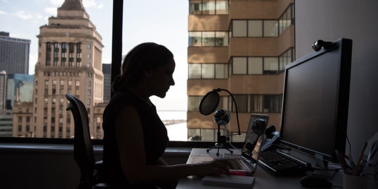 A woman sitting at her desk