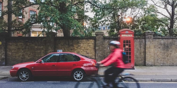 Bicycle and car in London ULEZ Expansion