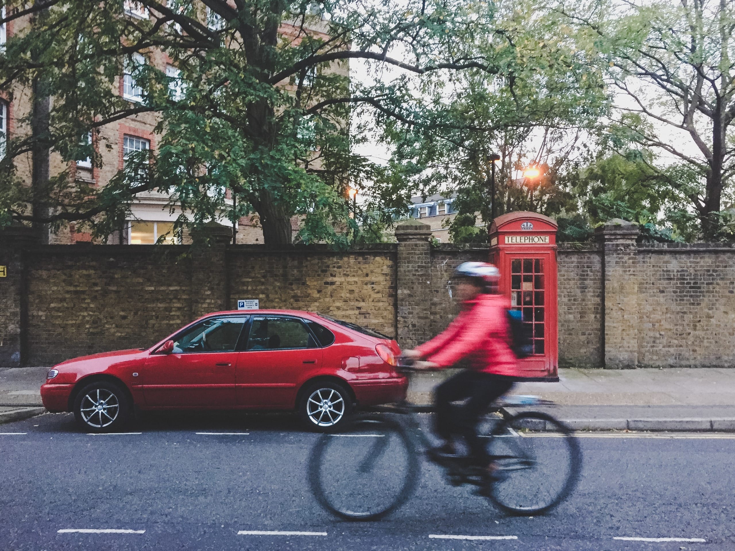 Bicycle and car in London ULEZ Expansion