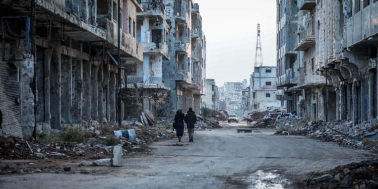 Two people walking through the rubble in the streets of Daraa, Syria before the earthquake