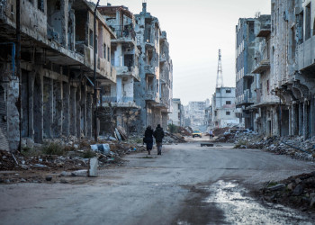 Two people walking through the rubble in the streets of Daraa, Syria before the earthquake