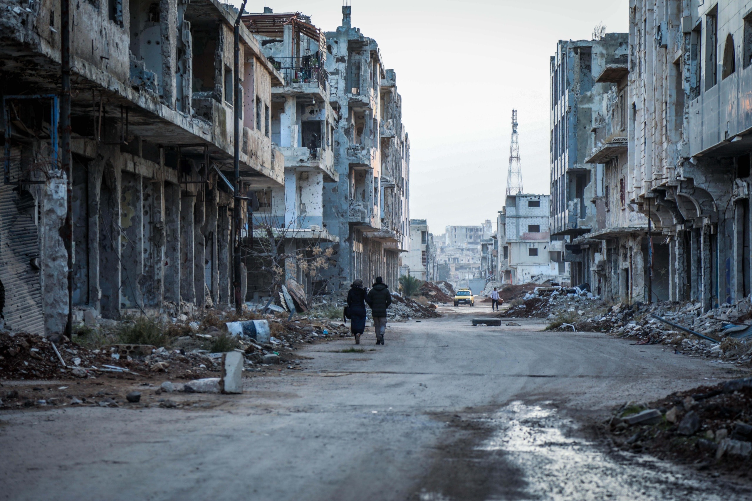 Two people walking through the rubble in the streets of Daraa, Syria before the earthquake