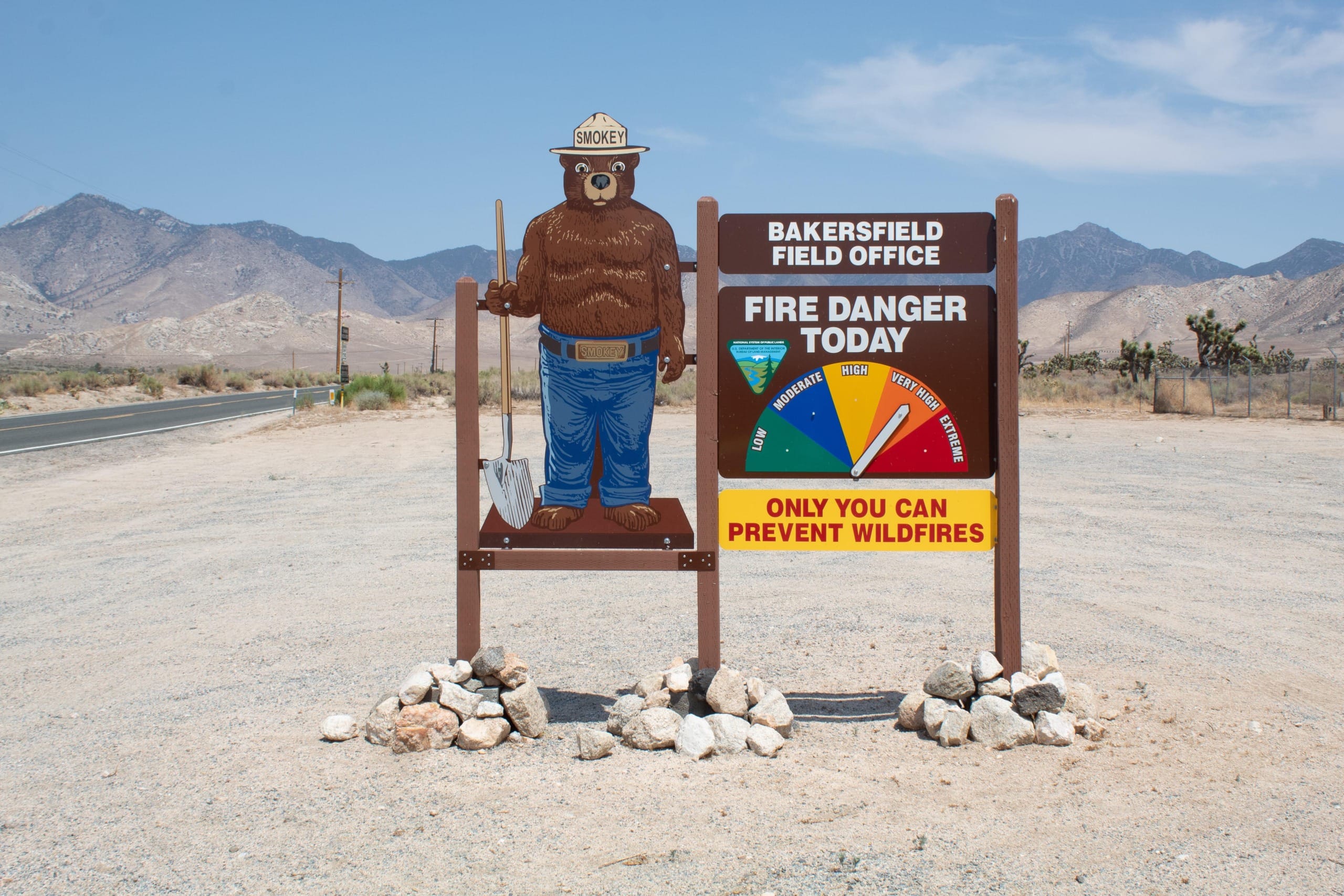 Smokey the Bear sign with risk of wildfires pinwheel