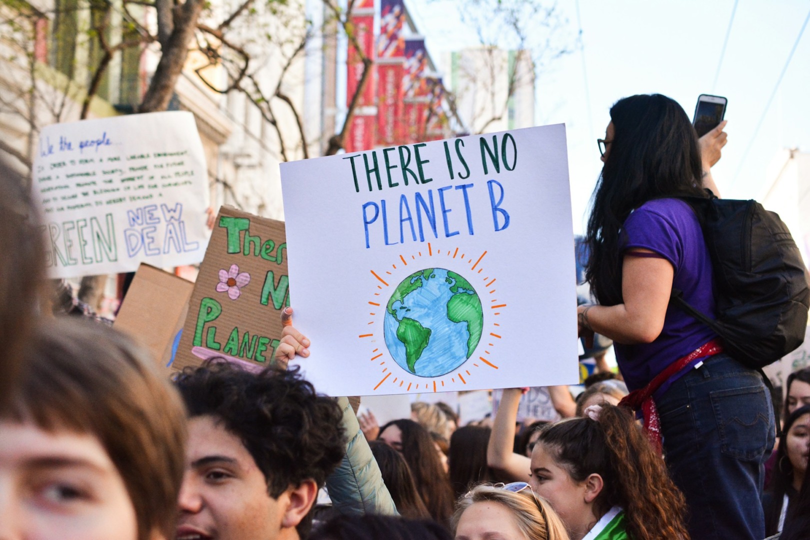 Youngsters hold banners, highlighting Gen Z’s commitment to sustainability and the role of ESG solutions in business.