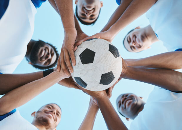 5 players putting their hand on a ball