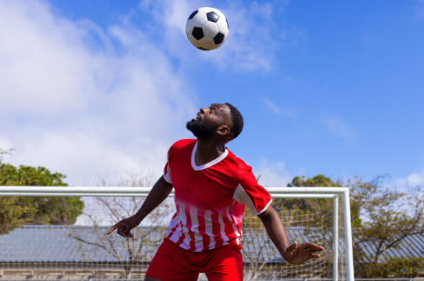 player bouncing a ball on his head