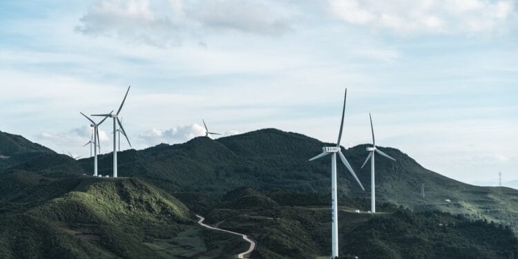 Offshore wind turbines at Gwynt y Môr, off the north Wales coast, under overcast skies. Smartphone showing the ChatGPT app, illustrating new PayPal instant checkout inside the chat. Electrolyzer stacks inside a hydrogen facility. Universal Music Group logo on a Zurich building facade.