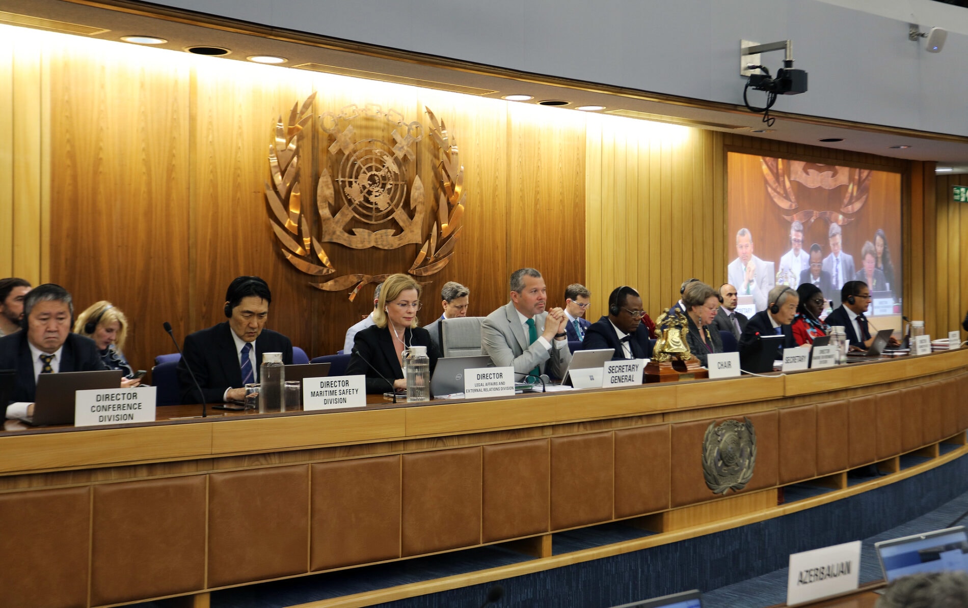 A row of people sit at a table for a meeting