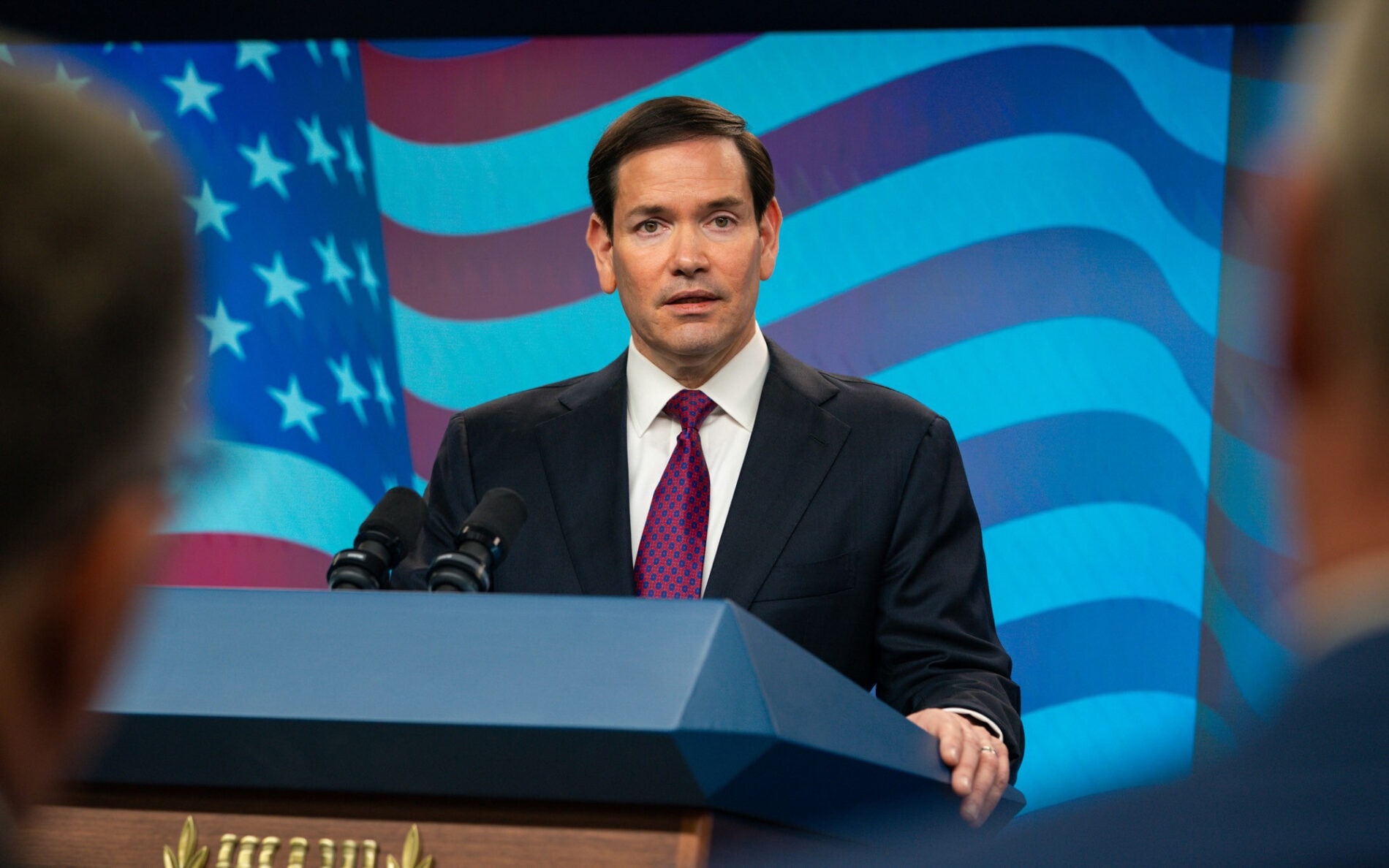 U.S. Secretary of State Marco Rubio speaks at a lectern.