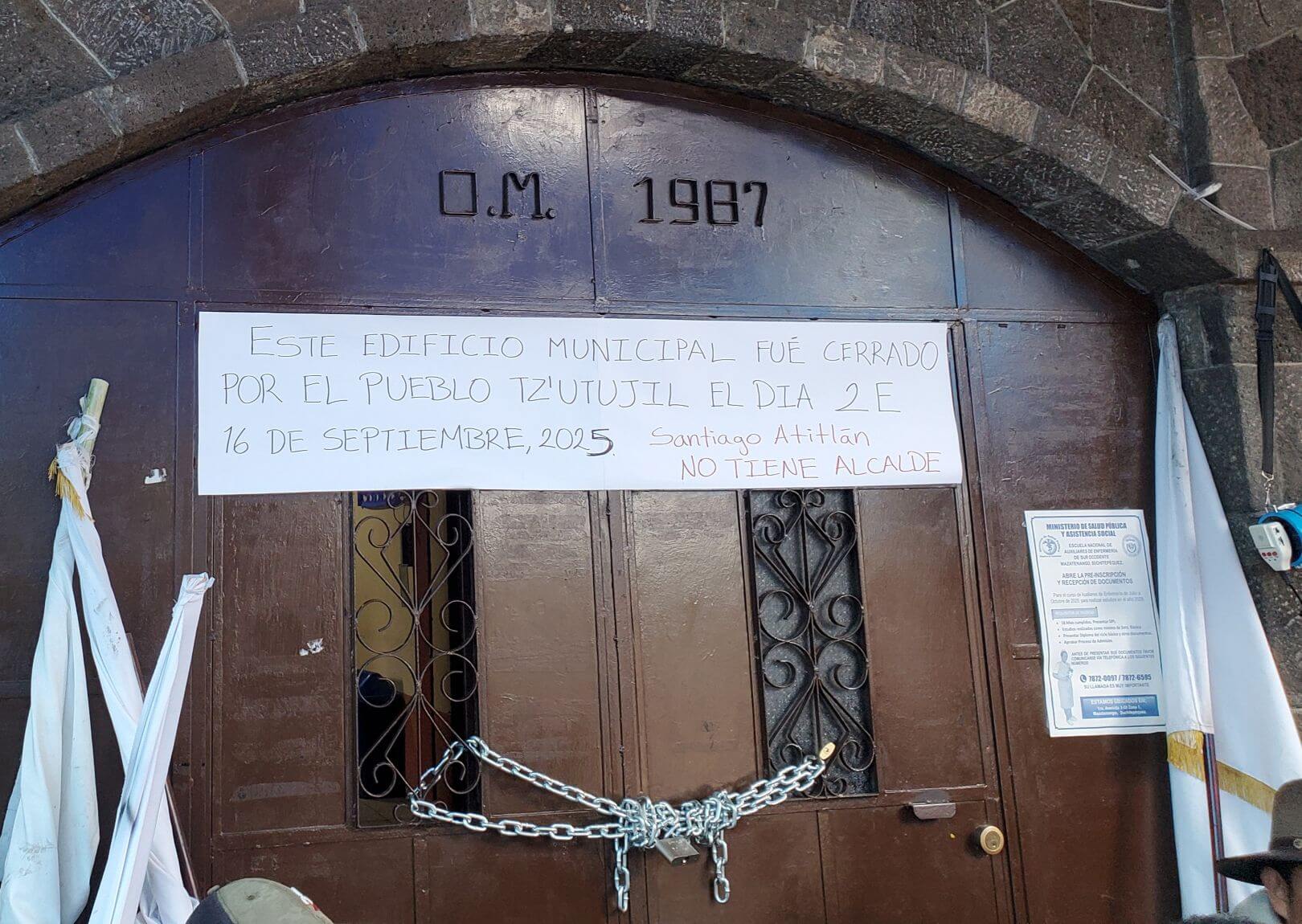 A large metal door is locked with a chain.