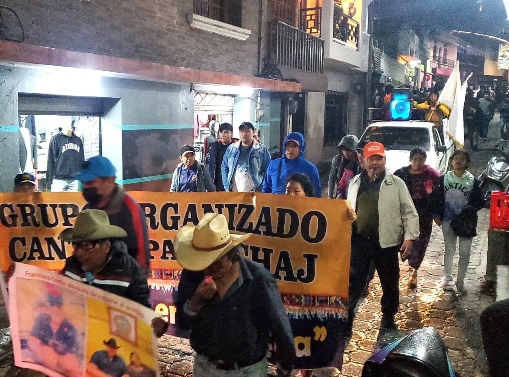 People carrying banners march through a city street.