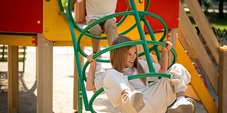 brother and sister playing in a playground