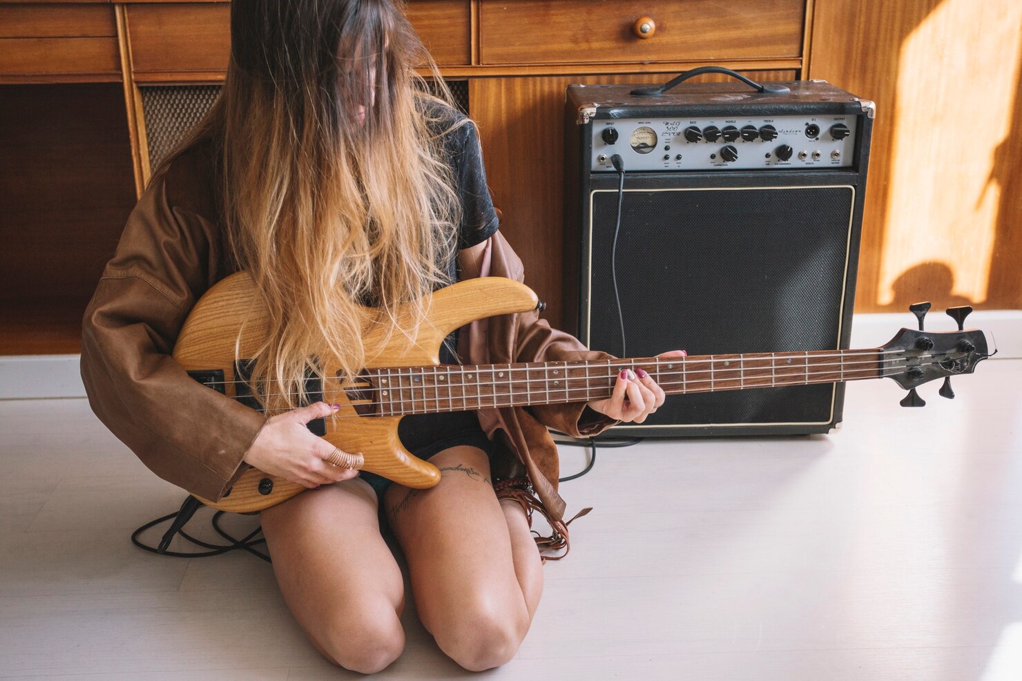 Woman playing an Electro-Acoustic Guitar