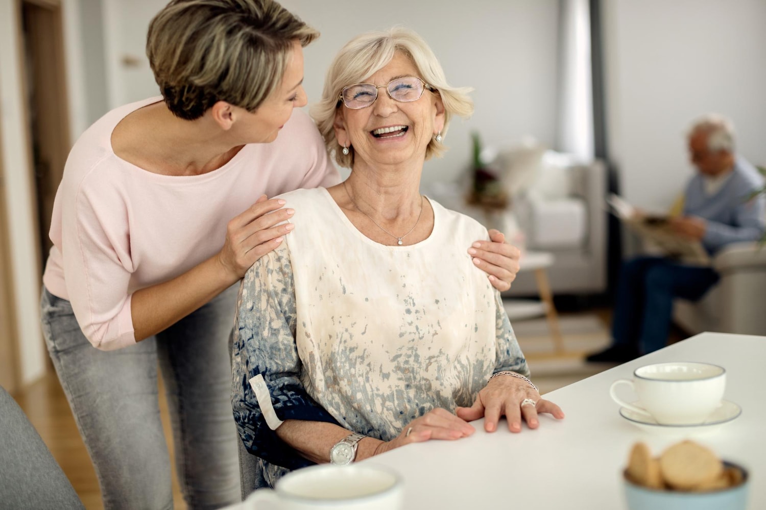 Home Care Support: Cheerful senior woman having fun with her adult daughter at home