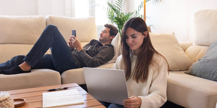 Couple in their living room, dealing with their home internet connection.