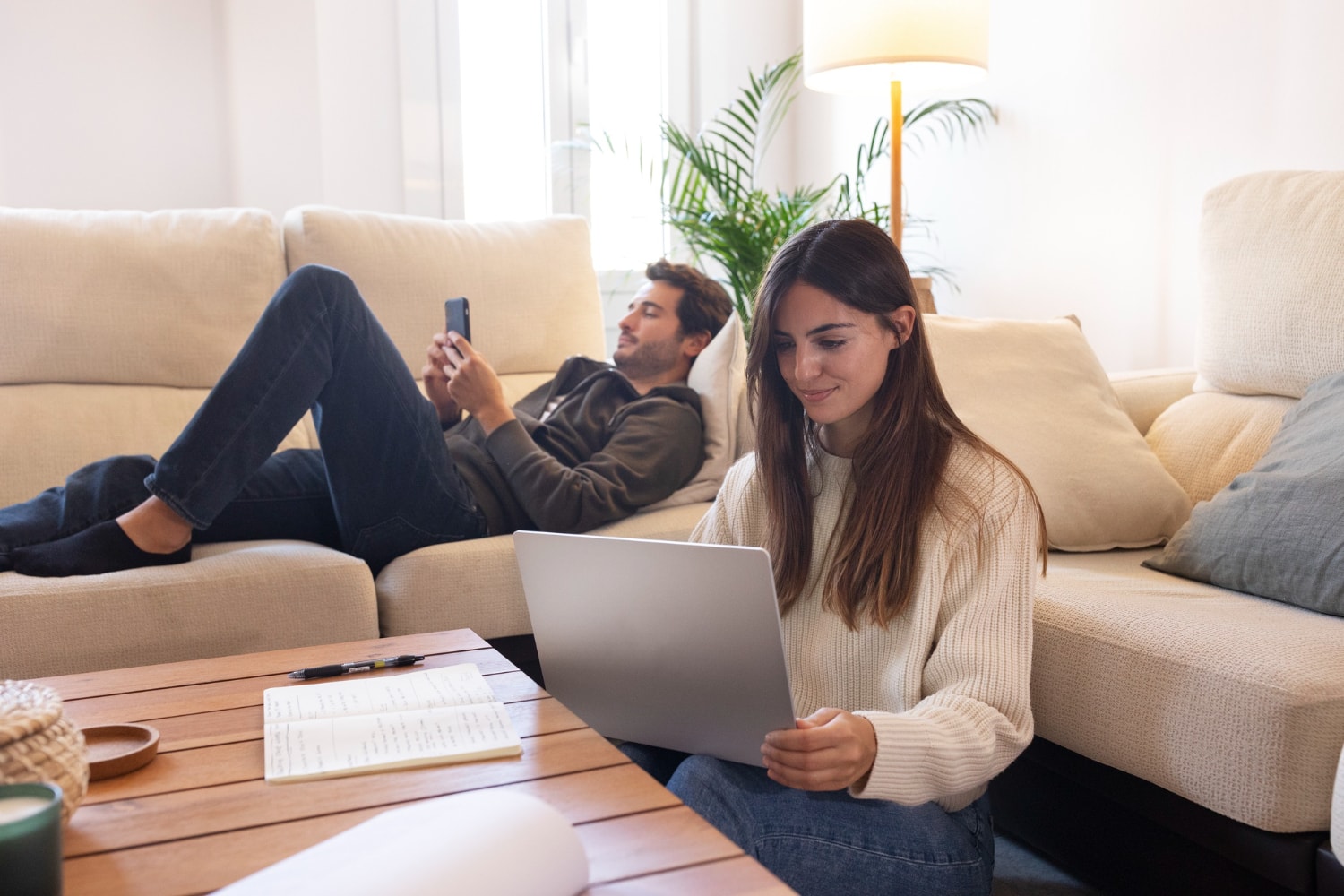 Couple in their living room, dealing with their home internet connection.
